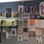 Many different posters on the wall at CONvergence 2023